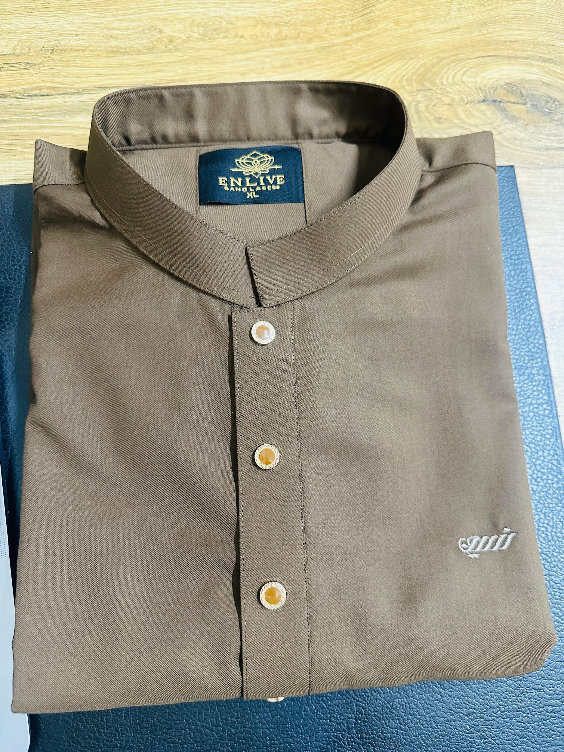 Folded brown shirt with a collar on a blue surface