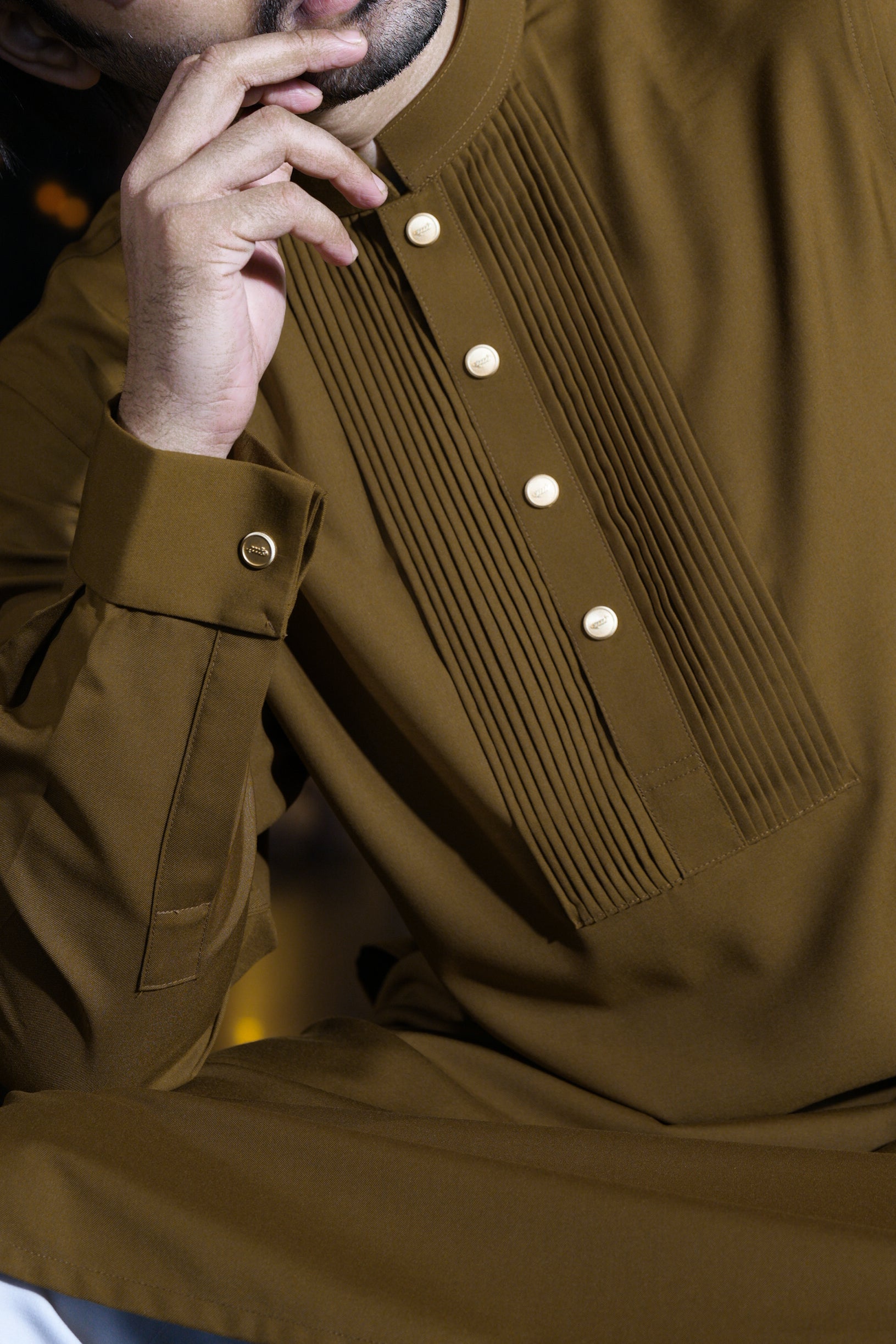 Close-up of a brown coat with button details