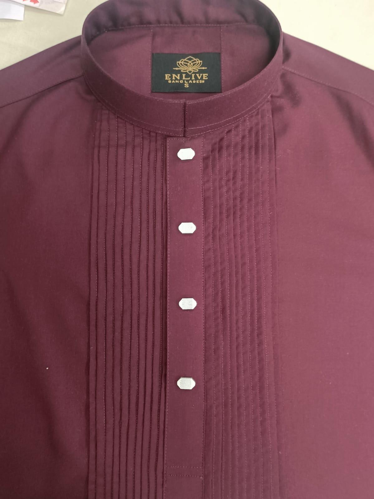 Maroon shirt with a brand label on a beige background