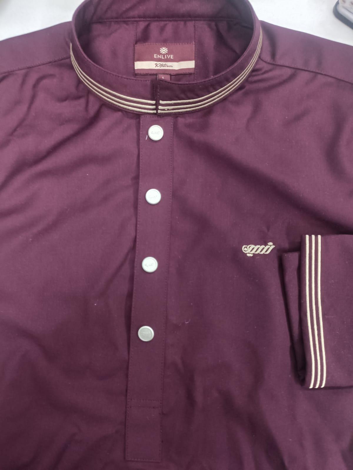 Close-up of a maroon shirt with buttons and a brand logo on a white background