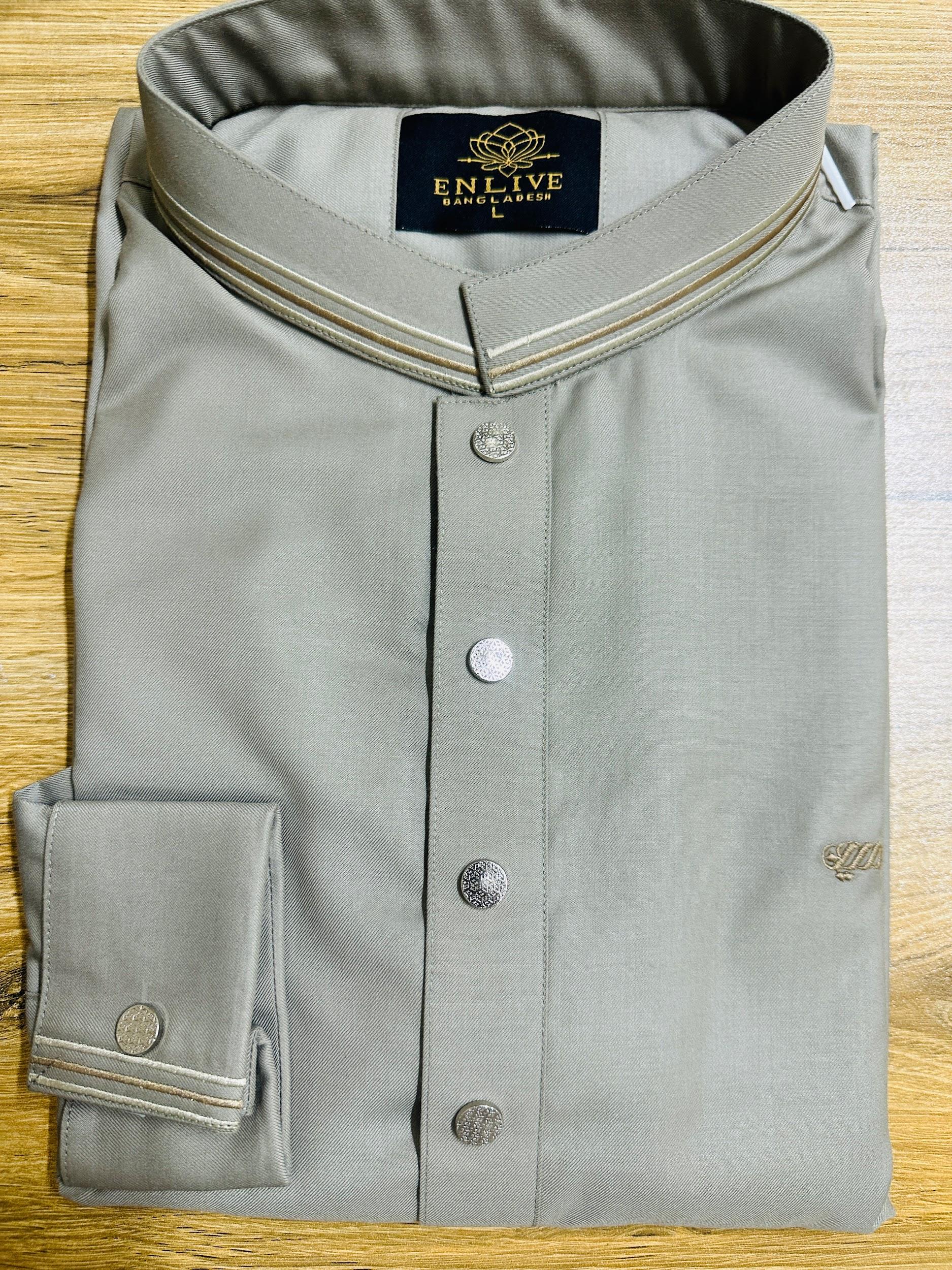 Folded gray shirt with a brand label on a wooden surface